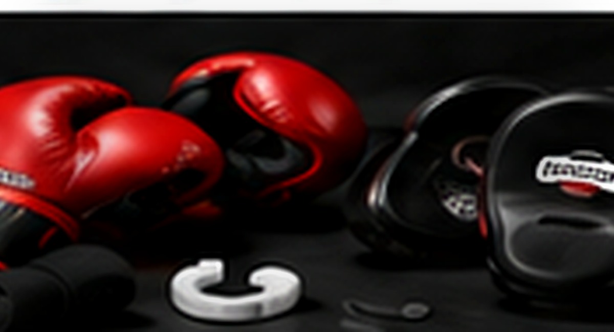 Red boxing gloves, focus mitts and mouthguard used in boxing fundamentals
